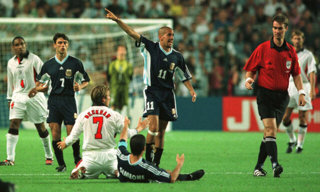 File photo dated 30/06/1998 of England's David Beckham (right) protests his innocence before being shown the red card by referee Kim Milton Neilsen for kicking Diego Simeone of Argentina (on floor).